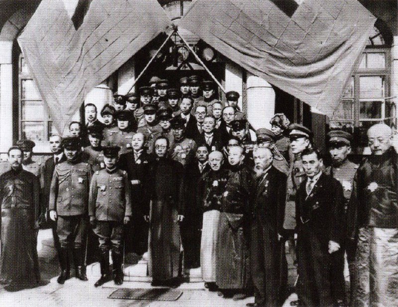 满洲国的国庆节1933年3月1日，人们庆祝“满洲国”国庆节前排中间戴眼镜的是溥仪，周围是日本军人